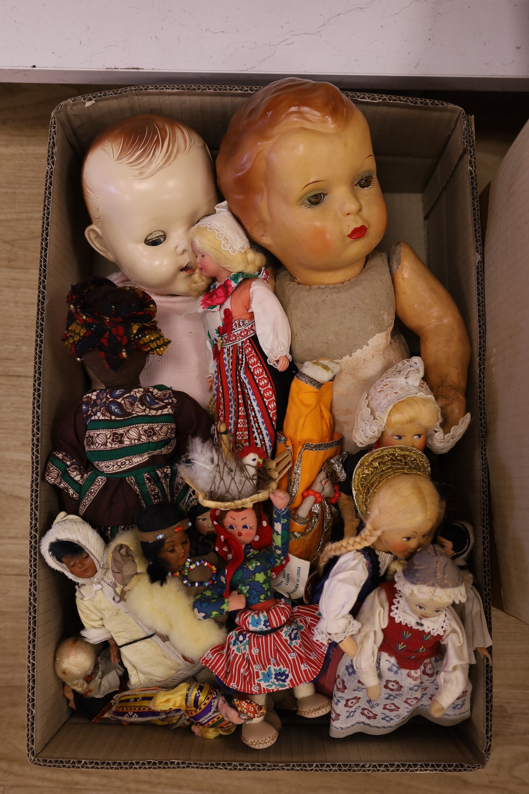 An assortment of soft toys, including Steiff and two dolls